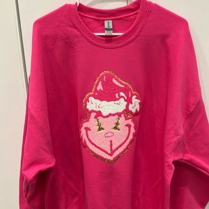 Pink Chenille Grinch on a pink sweatshirt.